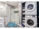 Bright bathroom features a glass shower and stacked washer and dryer at 1205 King St., Myrtle Beach, SC 29577