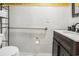 Bathroom featuring white tile, grab bar, dark wood vanity and black faucet at 1205 King St., Myrtle Beach, SC 29577