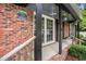 Close up of brick front porch with 'Beach' sign and greenery at 1205 King St., Myrtle Beach, SC 29577