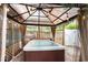 A hot tub is sheltered beneath a gazebo with curtains and decorative lighting at 1205 King St., Myrtle Beach, SC 29577