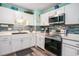 Bright kitchen featuring white cabinets, stainless appliances, and mosaic backsplash at 1205 King St., Myrtle Beach, SC 29577