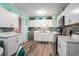 Updated kitchen with white cabinets, modern appliances, and blue mosaic backsplash at 1205 King St., Myrtle Beach, SC 29577