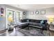 Living room with grey sectional, rug, board and batten detail, and large window at 1205 King St., Myrtle Beach, SC 29577