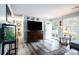 Open living room with fish tank, tv, front door, and decorative wall hangings at 1205 King St., Myrtle Beach, SC 29577