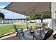 Inviting backyard patio with shade and a firepit, ideal for gatherings and relaxation by the water at 1209 Eagle Creek Dr., Myrtle Beach, SC 29588