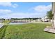 Expansive backyard with lush grass, a white picket fence, and serene water views at 1209 Eagle Creek Dr., Myrtle Beach, SC 29588