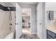 Well-lit bathroom featuring a shower-tub combo and modern fixtures, flowing to bedroom at 1209 Eagle Creek Dr., Myrtle Beach, SC 29588