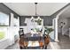 Charming dining room with an oval table, chandelier, gray walls, and beautiful natural light from a window at 1209 Eagle Creek Dr., Myrtle Beach, SC 29588
