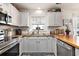 The kitchen features stainless steel appliances, decorative tile flooring, butcher block counters, and white cabinetry at 1209 Eagle Creek Dr., Myrtle Beach, SC 29588
