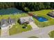 Aerial view of a landscaped home with a pond and backyard with well manicured lawns and mature trees at 142 Grier Crossing Dr., Conway, SC 29526