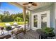 Cozy covered porch with ceiling fan, seating, and views of the lush green lawn and trees at 142 Grier Crossing Dr., Conway, SC 29526