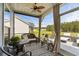 Charming screened-in porch with seating, ceiling fan, and views of the backyard at 142 Grier Crossing Dr., Conway, SC 29526