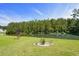 Lush backyard featuring a pond and manicured landscaping at 142 Grier Crossing Dr., Conway, SC 29526