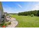 Expansive backyard features lush lawn, a border of river rock, and manicured plantings at 142 Grier Crossing Dr., Conway, SC 29526