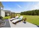 Spacious backyard featuring lounge chairs, lush green lawn, and tree line at 142 Grier Crossing Dr., Conway, SC 29526