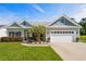 Charming single-story home with a well-manicured lawn, a two-car garage and nice landscaping at 142 Grier Crossing Dr., Conway, SC 29526