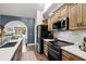 Modern kitchen featuring stainless steel appliances, wooden cabinets, and white countertops at 142 Grier Crossing Dr., Conway, SC 29526
