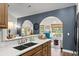Bright, open kitchen with bar seating, stainless steel sink and view into a naturally lit living space at 142 Grier Crossing Dr., Conway, SC 29526