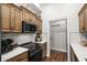 Galley kitchen with dark wood cabinets, stainless steel appliances, and modern countertops at 142 Grier Crossing Dr., Conway, SC 29526