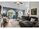 Spacious living room with a large sectional sofa, hardwood floors, and stylish decor at 142 Grier Crossing Dr., Conway, SC 29526