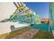 Vibrant Coastal Carolina Chant mural with colorful design near a miniature football field display at 142 Grier Crossing Dr., Conway, SC 29526