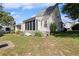 Exterior shot of a house with a screened in porch and landscaped backyard with green grass and a kayak at 1422 Baldwin Ct. # 1422, Little River, SC 29566
