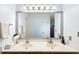 Double sink vanity with a large mirror and good lighting in a well-maintained bathroom at 1422 Baldwin Ct. # 1422, Little River, SC 29566