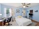 Bedroom featuring light blue walls, a ceiling fan, and a comfortable bed, creating a serene and inviting space at 1422 Baldwin Ct. # 1422, Little River, SC 29566