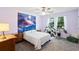 Bright bedroom featuring gray carpet, ceiling fan, windows and a decorative mountain tapestry on the wall at 1422 Baldwin Ct. # 1422, Little River, SC 29566