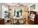 Charming dining area with bay windows, a round table, and decorative plants creating a warm atmosphere at 1422 Baldwin Ct. # 1422, Little River, SC 29566