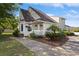 Charming exterior featuring a well-maintained lawn and colorful flowering plants on the porch at 1422 Baldwin Ct. # 1422, Little River, SC 29566