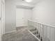 Carpeted upstairs hallway with a staircase and white railing, leading to the upper level of the home at 1422 Baldwin Ct. # 1422, Little River, SC 29566
