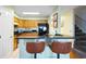 Open kitchen with bar seating, wooden cabinets, and black appliances offering a functional and stylish space at 1422 Baldwin Ct. # 1422, Little River, SC 29566