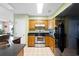 Well-lit kitchen with wood cabinets, stainless steel appliances, and tile flooring offering a clean and modern aesthetic at 1422 Baldwin Ct. # 1422, Little River, SC 29566