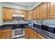 Efficient kitchen featuring stainless steel appliances, ample counter space, and classic wooden cabinets for storage at 1422 Baldwin Ct. # 1422, Little River, SC 29566