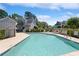 Community pool featuring a metal handrail, lounge chairs, and neighborhood housing at 1422 Baldwin Ct. # 1422, Little River, SC 29566
