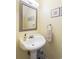 Charming powder room with a pedestal sink, decorative mirror, and soft lighting, ideal for guests at 1422 Baldwin Ct. # 1422, Little River, SC 29566
