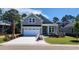 Inviting two-story home with a lush green lawn and attached two-car garage at 1424 Hydrangea Dr., Myrtle Beach, SC 29579