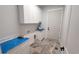 Well-lit laundry room with ample cabinet storage and modern white trim at 1424 Hydrangea Dr., Myrtle Beach, SC 29579