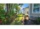 Well-maintained side yard with fresh landscaping and mature trees at 1424 Hydrangea Dr., Myrtle Beach, SC 29579