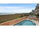 Spacious balcony overlooking the pool, dunes, and ocean, ideal for relaxation and coastal living at 1501 Ocean Blvd. S # 103, North Myrtle Beach, SC 29582