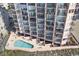 Aerial view of the condo with a swimming pool surrounded by beach chairs and outdoor furniture at 1501 Ocean Blvd. S # 103, North Myrtle Beach, SC 29582