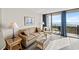 Bright living room with cozy seating, ocean view, and balcony access through sliding glass doors at 1501 Ocean Blvd. S # 103, North Myrtle Beach, SC 29582