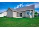 Back exterior of the home showing the patio and green lawn at 176 Springtide Dr., Conway, SC 29527