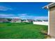 View of the backyard with lush green grass and a partial fence at 176 Springtide Dr., Conway, SC 29527