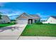 Inviting single-Gathering home with a well-kept lawn, neutral exterior, and convenient two-car garage at 176 Springtide Dr., Conway, SC 29527