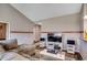 Bright living room features hardwood floors and a comfortable sectional sofa with entertainment center at 176 Springtide Dr., Conway, SC 29527