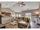 Open living area with vaulted ceilings, fan, hardwood floors, and a comfortable sectional sofa at 176 Springtide Dr., Conway, SC 29527
