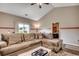 Bright living room boasts hardwood floors, a comfortable sectional sofa, and sliding glass door to the yard at 176 Springtide Dr., Conway, SC 29527