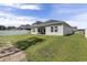 Picture of a spacious backyard with green grass, white fence, and covered patio with furniture at 179 Empyrean Circle, Myrtle Beach, SC 29588